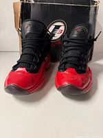 Front view of both sneakers with box