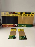 All seven unopened 3M sandpaper packs, showing Wetordry and General Purpose varieties