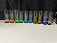 Front view of all ten shot glasses showing color variety