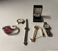 All six watches arranged on table