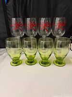 Front view of all eight glasses showing design and colors