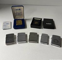 Overview of all five lighters, cases and boxes