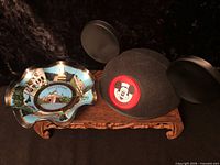 Decorative plate and Mickey ear hat on display stand