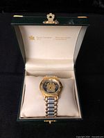 Watch displayed inside open green Royal Canadian Mint box