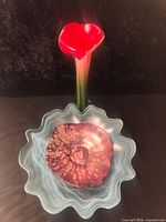 Vase with red heart top set inside ruffled plate with purple plate resting within