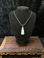 Pendant on display bust with scale reference