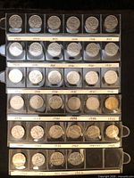 Sleeved coins reverse side visible, grouped by year