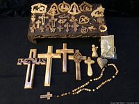 Full lot overview showing ornaments on wooden tray, crucifixes, rosary, small figures, keychains