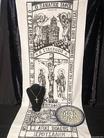 Full view of shroud, crucifix necklace on display bust, and plate