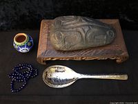 All items: beadworked vase, stone bowl on stand, bead strand, spoon