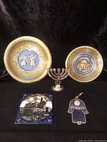 Overview showing plates, menorah, tile, Hamsa