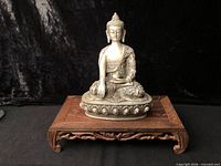 front view of Buddha figure on stand