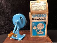 Bean slicer assembled beside box, showing overall appearance