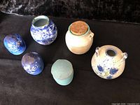 Group of six pottery pieces laid out