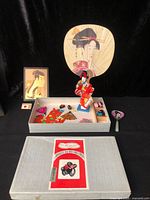 Overall lot with geisha doll, mirror, print, large fan, box and accessories visible