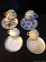 Group shot of five cup and saucer sets showing all patterns