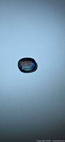 Top view of oval blue sapphire on neutral background