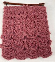 Front view of full crocheted purse showing purple shell stitch and brown leather handle