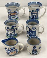 All six pieces grouped: two large tea mugs, two smaller coffee mugs, cream pitcher, sugar bowl