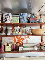 Overall shelves with tins, glassware, basket
