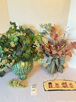 Full lot showing vase with greenery, dried bouquet, grape cluster, wooden plaque
