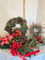 Overall view of four-piece lot showing main wreath, twig wreath, garland and small wreath/swag