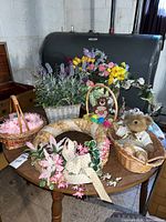 Overall view showing wreaths, baskets, flowers, teddy bear