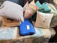 All pillows and blankets stacked on bed