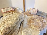 Overall lot showing crochet tablecloth, filet lace, embroidered and blue napkins