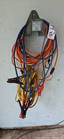 Cables and bungees hanging on wall rack