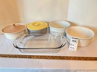 Front angled view of all five pieces showing shapes, lids and ruler for scale