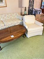 Coffee table and armchair side by side showing size, shape and finish