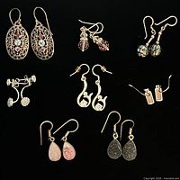 Group shot of all eight earring pairs on black background