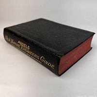 Book spine and fore-edge showing red-stained pages and title