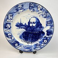 Full view of flow blue Shakespeare plate on stand