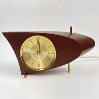 Front view showing dial, wood case and feet