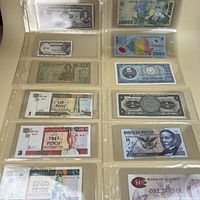 Binder page showing eight different banknotes front side