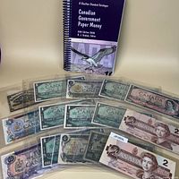 Front view showing Charlton catalogue and several binder sheets of Canadian bank notes