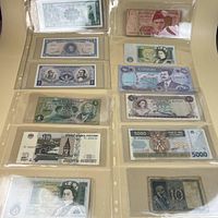 Binder page showing twelve assorted banknotes, fronts visible