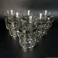 Front angled view of all six glasses with metal sleeves