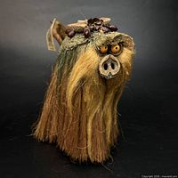 Full view of troll figure showing body, hair, tail and head adornments