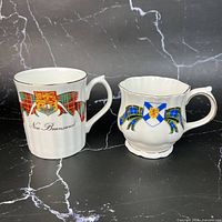 Front view of both provincial tartan mugs