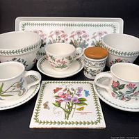 Full lot showing bowls, cups with saucers, tray, tile, canister