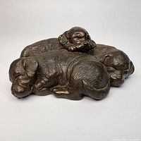 Top view of bronzed puppy litter figurine