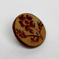 Stamping face showing botanical flower relief