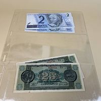 Set of four banknotes in plastic sleeve, Brazil 2-Reais on top, Greece 25-Drachmai below