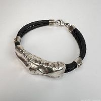 Full view of bracelet showing silver centerpiece and leather strap