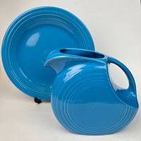 Front view of turquoise plate and pitcher showing color and ring design