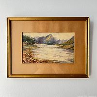 Straight-on view of framed watercolour landscape