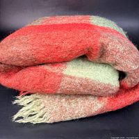 Rolled plaid mohair blanket showing colors and texture